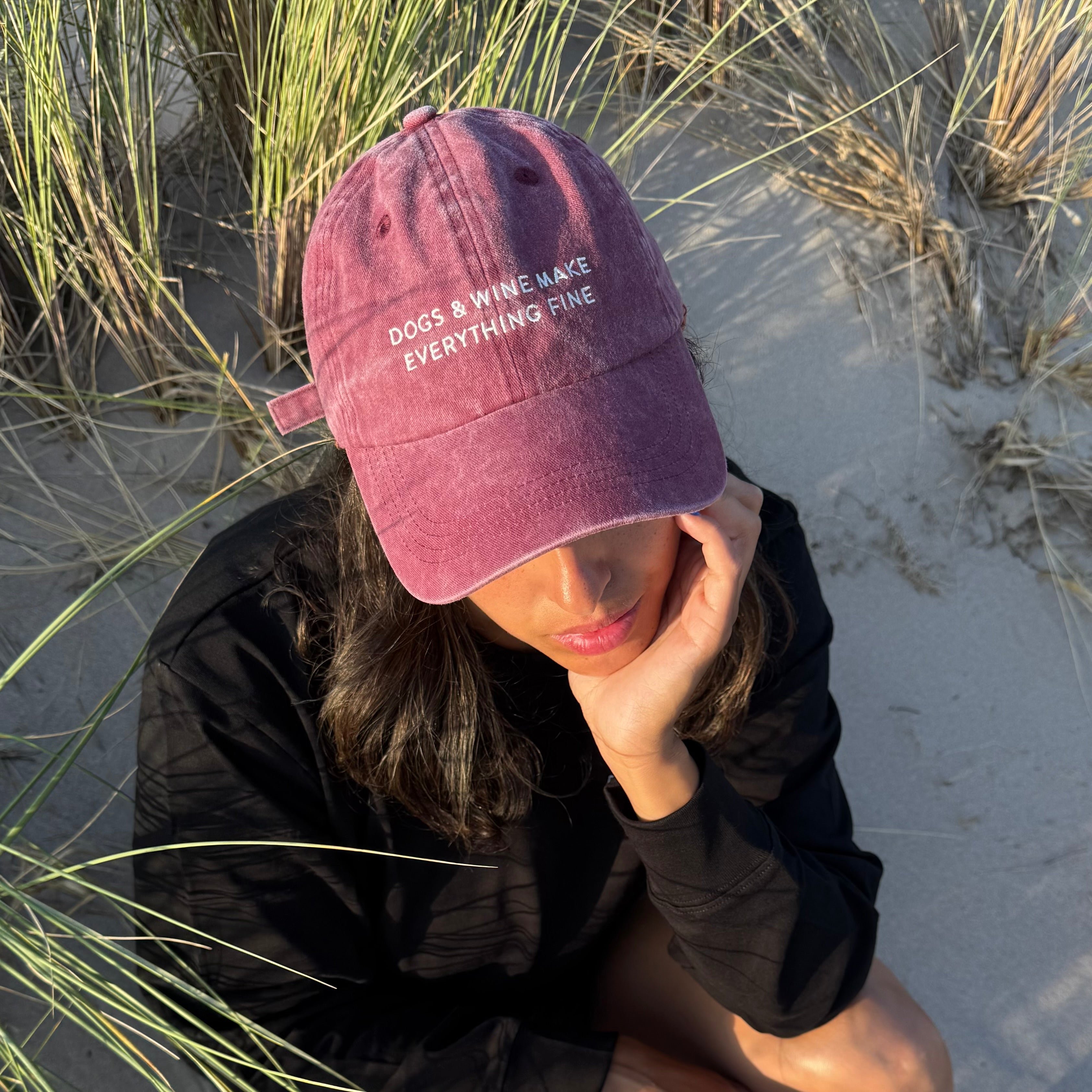 dark-red-denim-cap-dogs-wine-woman-beach.jpg